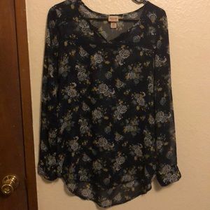 Light, floral top with long sleeves.